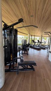 a gym with a row of treadmills and machines at Casa Marimar Milagres- Praia do Marceneiro in Passo de Camarajibe