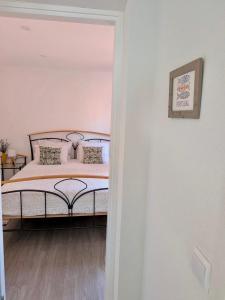 a bedroom with a bed and a picture on the wall at Alojamento Lazer in Folgosa