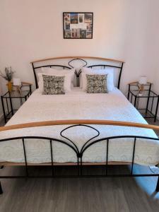 a bedroom with a large bed with white sheets and pillows at Alojamento Lazer in Folgosa