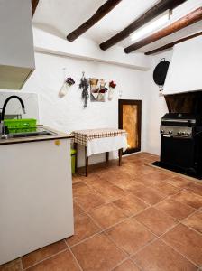 a kitchen with a counter and a table in a room at Casa Josefa Xiva Morella in Chiva de Morella