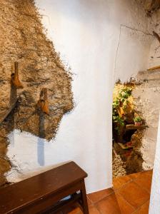 a wall in a room with a bench next to it at Casa Josefa Xiva Morella in Chiva de Morella