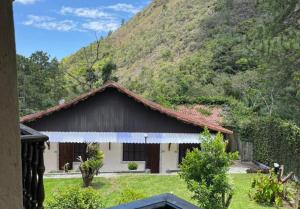 a house with a mountain in the background at Alto Paraiso in Teresópolis