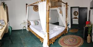 a bedroom with a wooden bunk bed with white sheets at Beach Bungalows Costinesti in Costinesti +39 photos