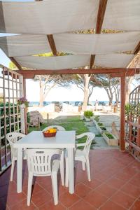 a white table and chairs on a patio at Stella Marina Budoni in Budoni