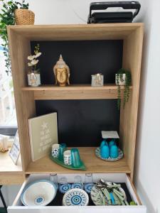 a wooden shelf with plates and dishes on it at Beach Bungalows Costinesti in Costinesti