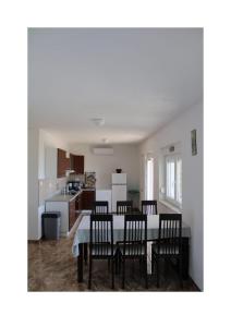a kitchen with a dining room table and chairs at Villa Noah Apartement 2 in Novi Vinodolski