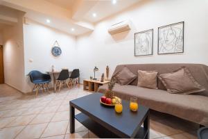 a living room with a couch and a table at Rosso 3 City Centre Apartment in Heraklio
