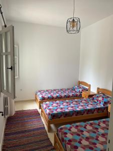 a room with three beds in a room at Arabesque-style apartment in Yasmine +10 photos