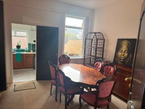 a dining room with a table and chairs at Crosby & Waterloo Beachside Stay in Waterloo