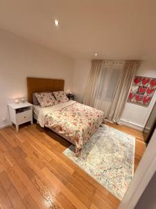 a bedroom with two beds and a rug at Maison avec piscine proche de Paris in Groslay