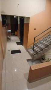 a hallway with a staircase in a building at PaoLia Meublé 3 in Cotonou