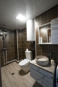 a bathroom with a toilet and a sink at Koruld Ushguli in Chvibiani