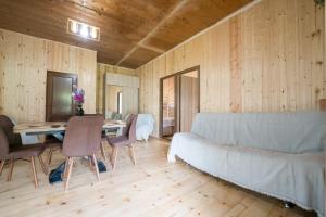 a living room with a couch and a table at Koruld Ushguli in Chvibiani +16 photos