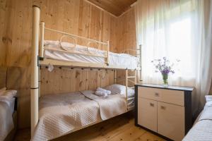 a bedroom with two bunk beds and a window at Koruld Ushguli in Chvibiani