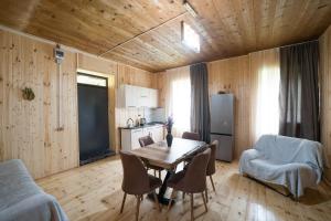 a kitchen and dining room with a table and chairs at Koruld Ushguli in Chvibiani