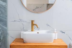 a bathroom with a sink and a mirror at Sand In My Shoes in Muizenberg +14 photos