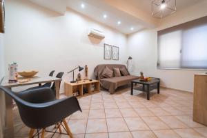 a living room with a couch and a table at Rosso 3 City Centre Apartment in Heraklio