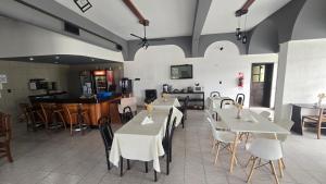 a dining room with white tables and chairs at Hotel barrica in Realicó