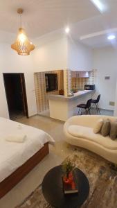 a large room with two beds and a table in it at PaoLia Meublé 3 in Cotonou