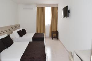Voodi või voodid majutusasutuse Hotel Kurakatá toas