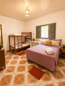 a bedroom with a bed and a bunk bed at Casa de Alter - Hospedaria e Experiências in Alter do Chao