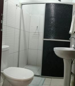 a bathroom with a shower and a toilet and a sink at Casa de Alter - Hospedaria e Experiências in Alter do Chao +16 photos