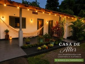 a house with lights and plants in front of it at Casa de Alter - Hospedaria e Experiências in Alter do Chao