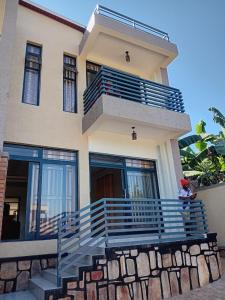 a person sitting on the steps of a house at Star real in Kigali
