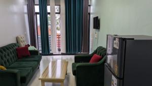 a living room with green couches and a coffee table at Star real in Kigali