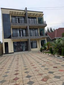a large house with a large courtyard in front of it at Star real in Kigali