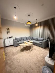 a living room with a couch and a table at أوبال ستاي المطار in Abha +36 photos