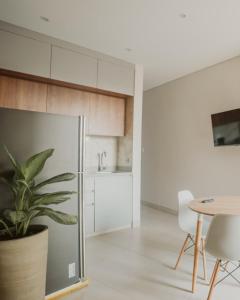 a kitchen with a table and a potted plant at Magaly House in Sincelejo