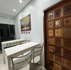 a dining room with a table and chairs and a door at Hotel Lara - Simolândia in Alvorada do Norte  +9 photos
