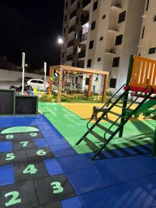 a playground with two chairs and a basketball court at Lunar Prime Aruana in Aracaju