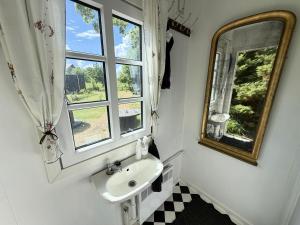 a bathroom with a sink and a mirror at Nøddehaven in Eg +65 photos