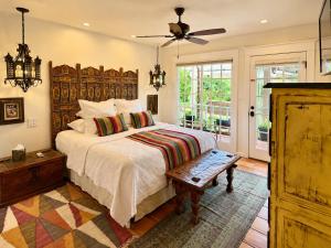 a bedroom with a large bed and a ceiling fan at Casa Culinaria - The Gourmet Inn in Santa Fe