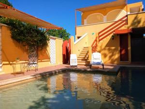 a house with a swimming pool next to a house at Hotel Santa Ana in Valladolid