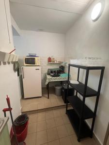 a small kitchen with a refrigerator and a table at Görbeút Vendégház in Vigántpetend