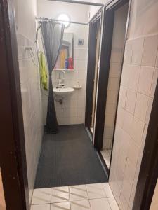a bathroom with a shower and a sink and a mirror at Görbeút Vendégház in Vigántpetend +12 photos