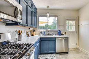 a kitchen with blue cabinets and a sink at The Cottage on Corinth in Seneca