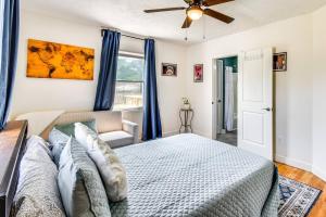 a bedroom with a bed and a ceiling fan at The Cottage on Corinth in Seneca
