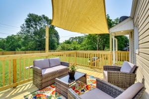 a patio with wicker chairs and a table on a deck at The Cottage on Corinth in Seneca