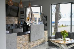 a restaurant with a counter with a boat on it at Dom Żeglarza in Puck