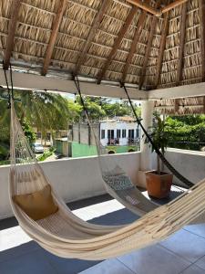 a couple of hammocks hanging from a roof at Casa Alma de Mar in Brisas de Zicatela