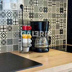 a kitchen counter with a blender and a tile wall at GC - Le Panorama - Front de Mer in Wissant