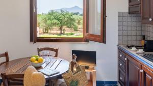 a kitchen with a table with a bowl of fruit on it at Le Casette a Favignana in Favignana