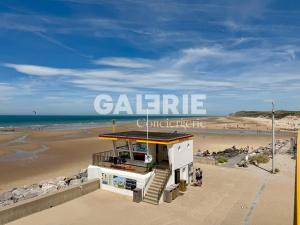 a lifeguard station on a beach with the words galerie at GC - Le Panorama - Front de Mer in Wissant
