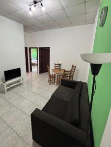 a living room with a couch and a table at Victoria Centre 2BR - Opposite Bus Terminal in Victoria