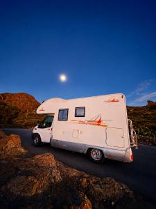 a white camper truck parked on a road at CamperTenerife in Callao Salvaje