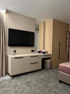 a living room with a flat screen tv on a wall at No 11 Residence in Krynica Morska
